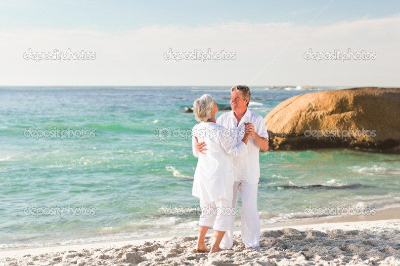 Retired couple dancing on the beach