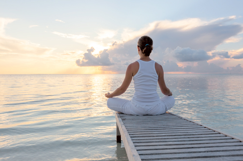 Caucasian Woman Practicing Yoga At Seashore